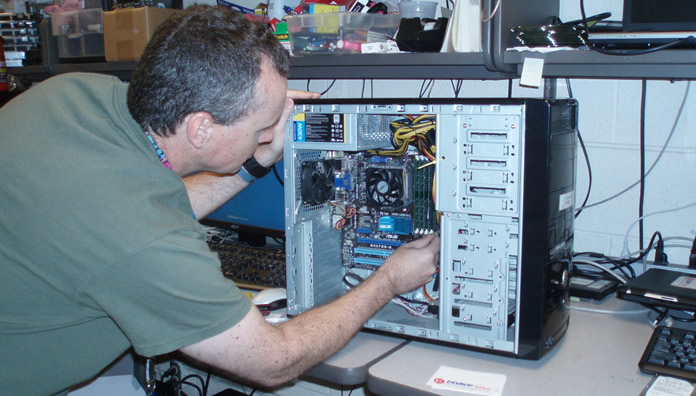 Andy Wolf fixing computer