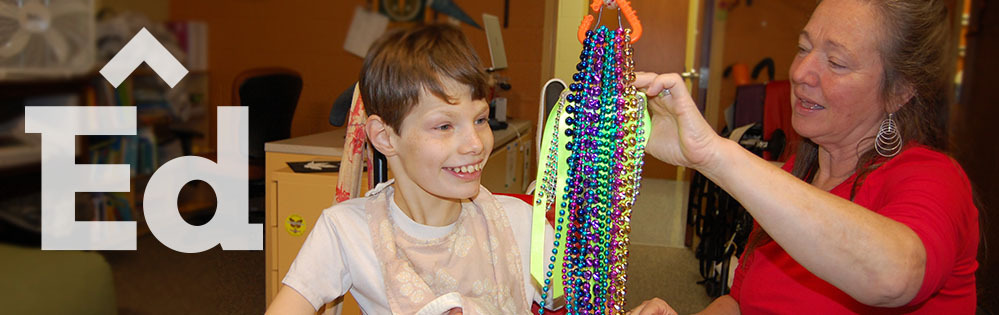 Smiling student at TBAISD center for students with cognitive impairments.