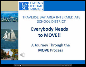 TBAISD logo with photos of a tall ship with sails  and downtown Traverse City Michigan.