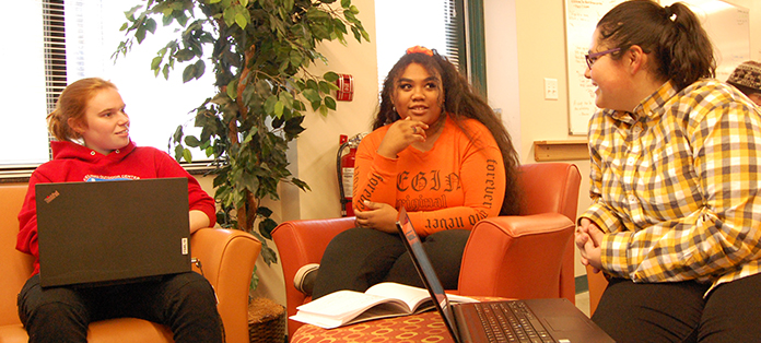 Three female students talking in the student lounge.